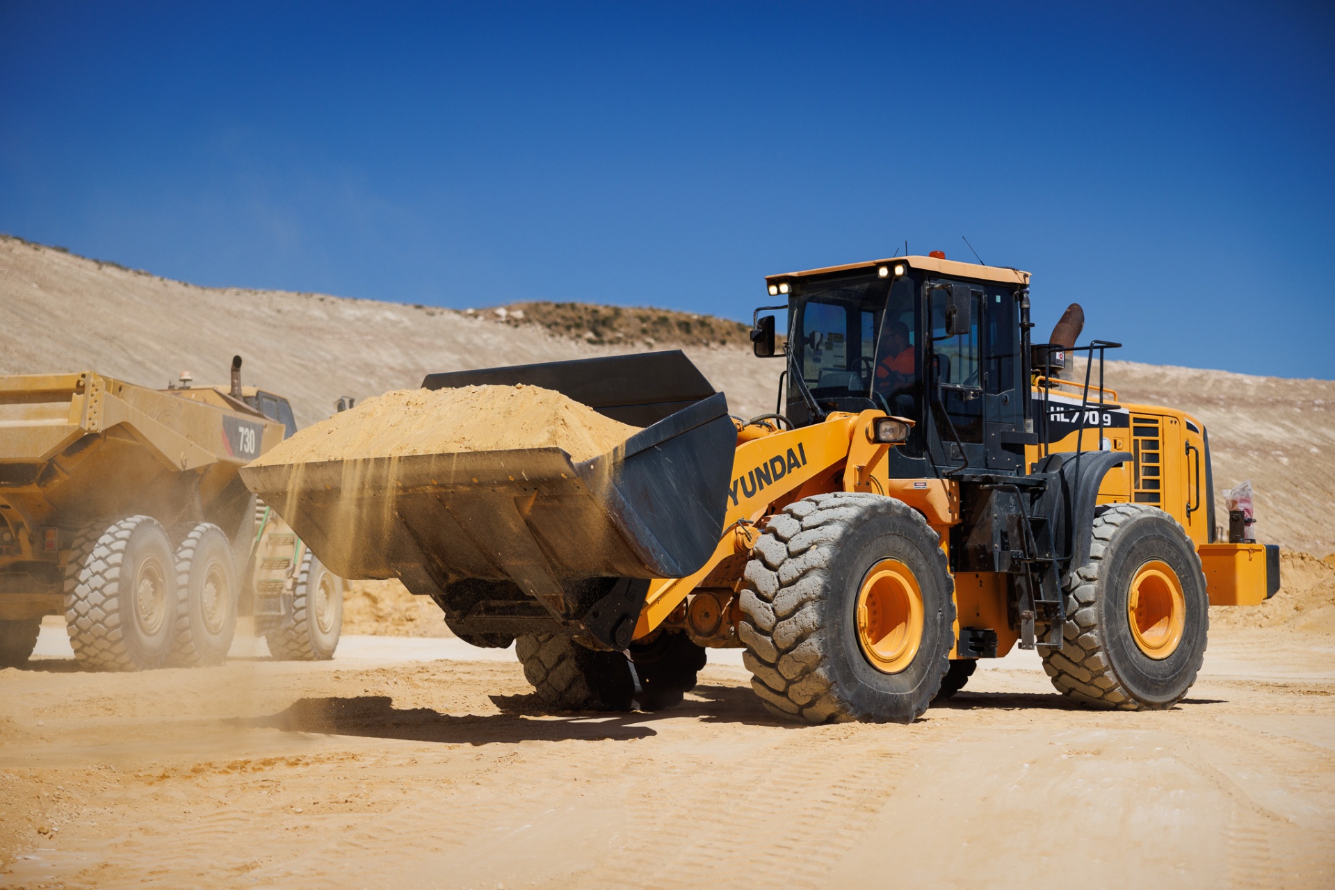 Wheel loader loading articulated truck