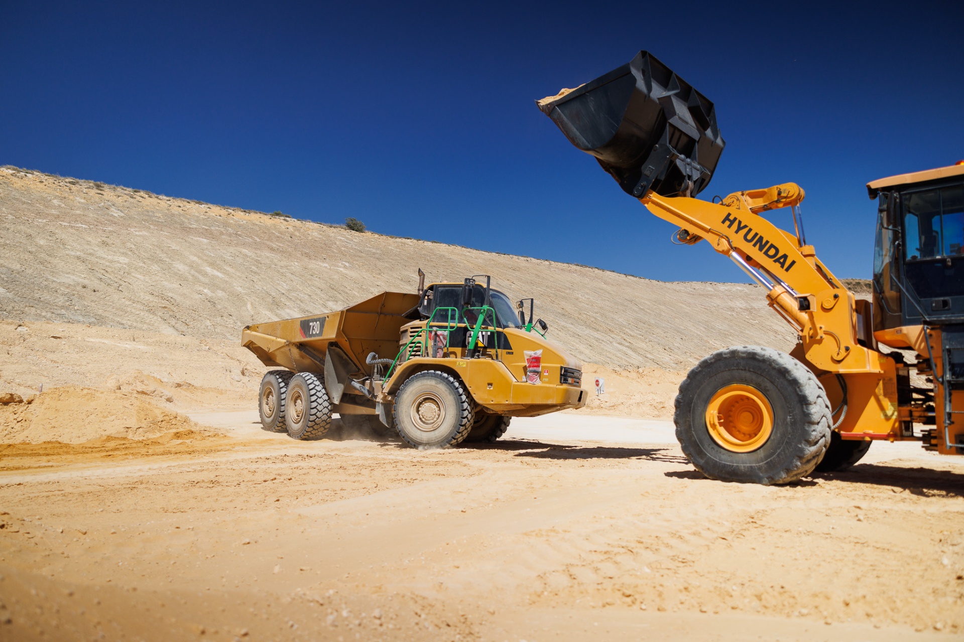 Moxy training Perth — wide view of articulated dump truck operations on mine site